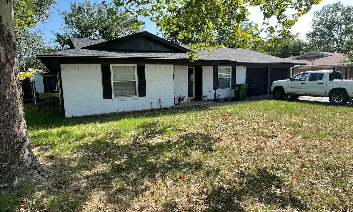 Professional roofing crew working on a residential roof in Shawnee